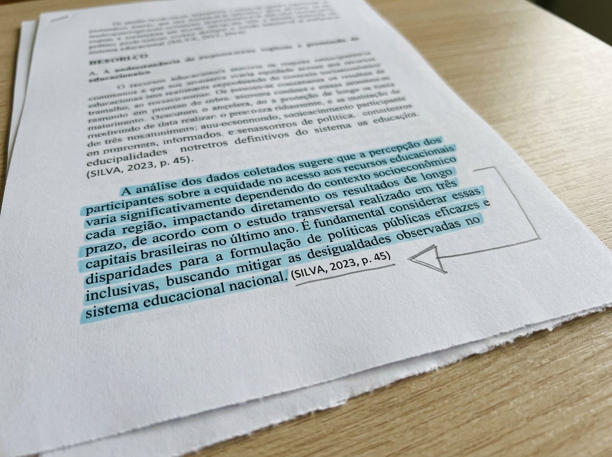 Pagina impressa com paragrafo entre aspas destacado e seta a lapis apontando para a referencia